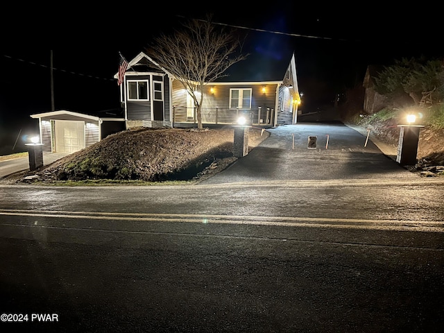 view of front of house with a storage shed