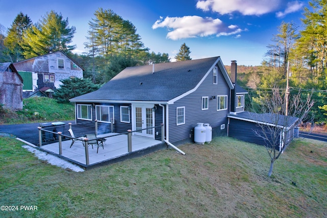 rear view of house featuring a lawn, a patio area, and french doors