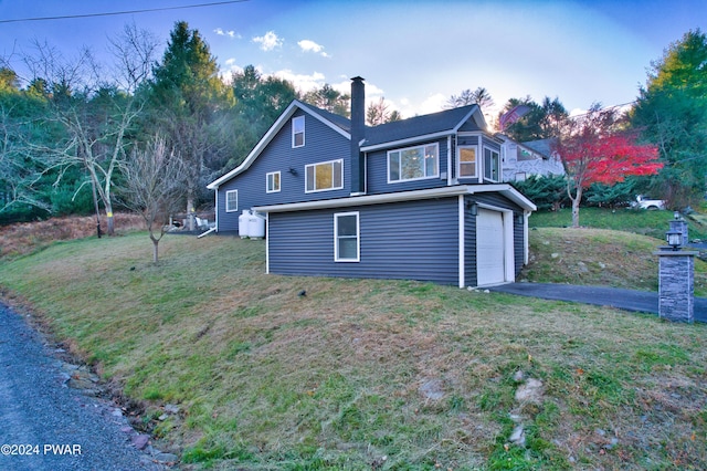 view of home's exterior with a lawn and a garage