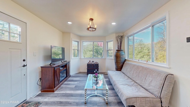 living room featuring an inviting chandelier and light wood-type flooring