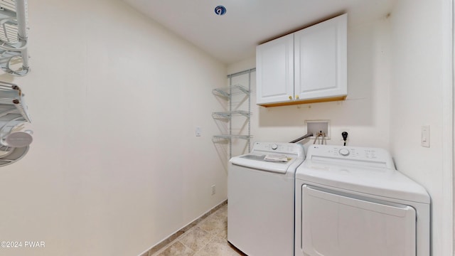 washroom featuring cabinets and separate washer and dryer