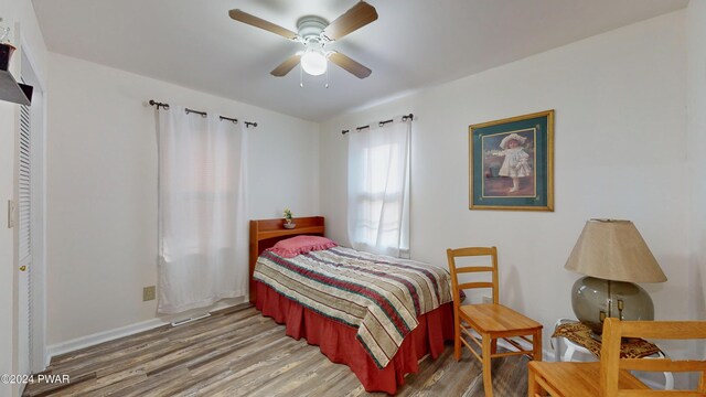 bedroom with hardwood / wood-style flooring and ceiling fan