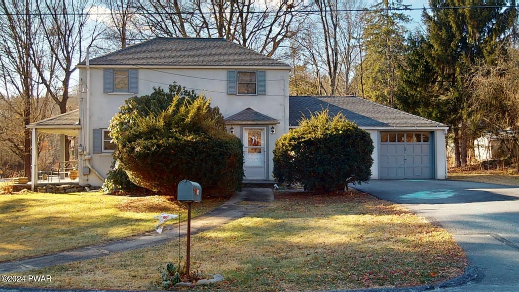 view of front of home with a garage and a front yard