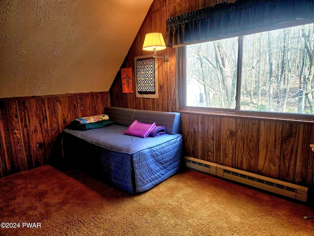 carpeted bedroom with multiple windows, baseboard heating, lofted ceiling, and wooden walls