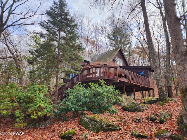 rear view of house featuring a deck