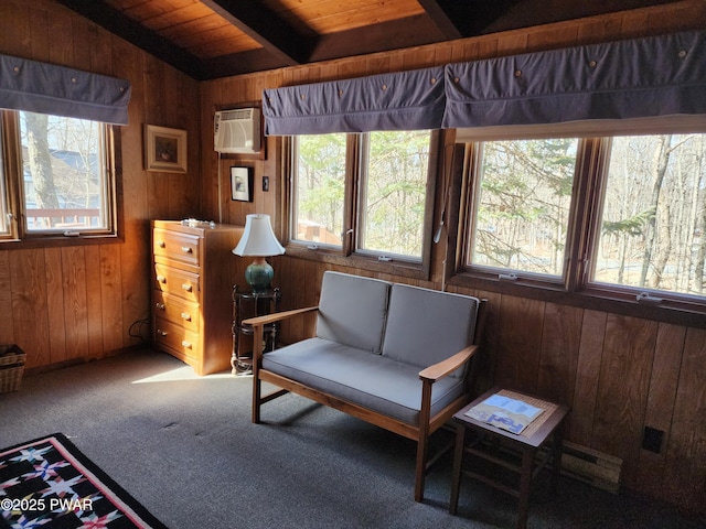 living area with beam ceiling, wood walls, and a wall mounted AC