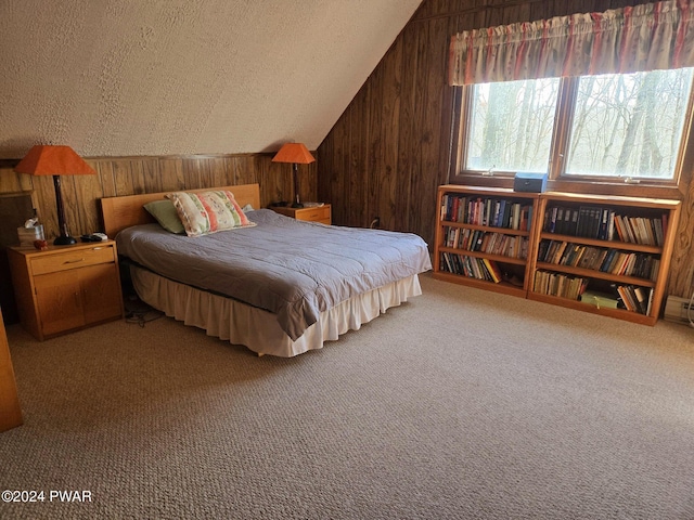 carpeted bedroom featuring lofted ceiling, wooden walls, and a textured ceiling