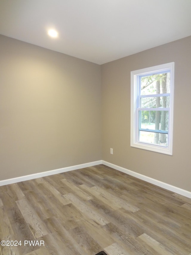 unfurnished room featuring baseboards and wood finished floors