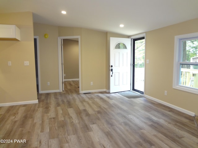 foyer entrance featuring light wood finished floors, baseboards, and recessed lighting