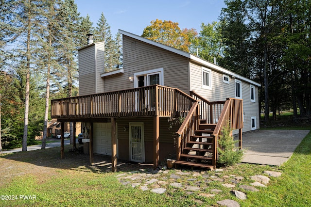 back of house featuring a garage and a deck