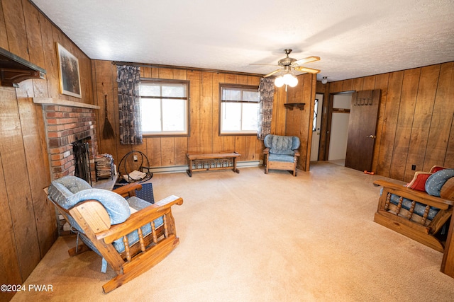 sitting room featuring light carpet, ceiling fan, and wooden walls