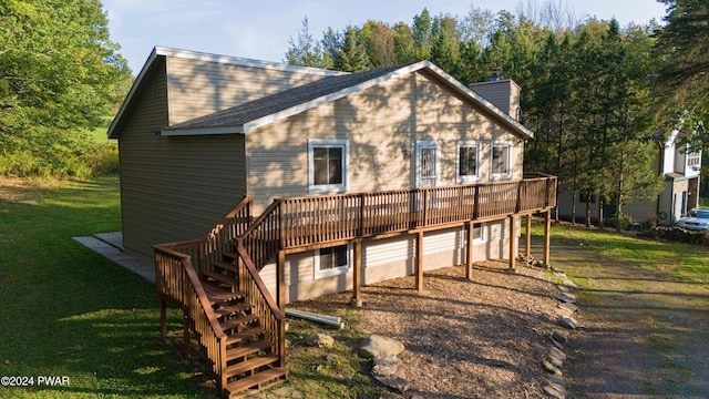 back of property with a deck and a lawn