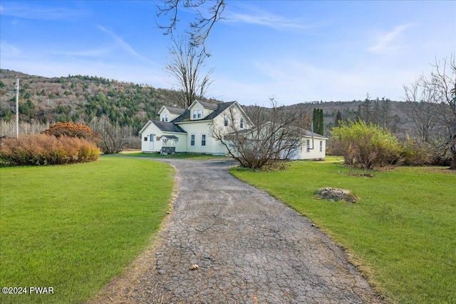 cape cod-style house with a front yard