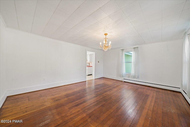 unfurnished room featuring a chandelier, hardwood / wood-style floors, and a baseboard radiator