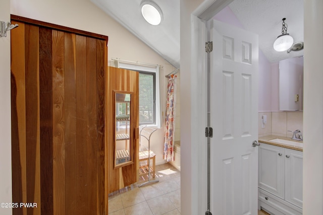 116 Rainbow Dr, Lackawaxen, PA 18435 - hallway featuring a sink, lofted ceiling, and light tile patterned floors