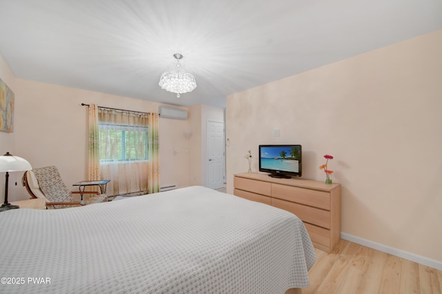 116 Rainbow Dr, Lackawaxen, PA 18435 - bedroom with a wall mounted AC, light wood-style floors, baseboards, a chandelier, and baseboard heating