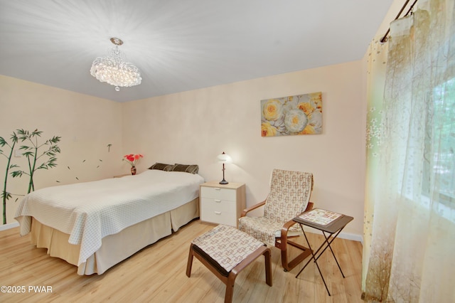 116 Rainbow Dr, Lackawaxen, PA 18435 - bedroom with light wood-type flooring, a chandelier, and baseboards