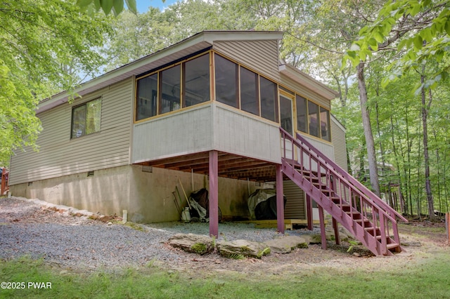 116 Rainbow Dr, Lackawaxen, PA 18435 - back of property with a sunroom, a carport, stairs, and driveway