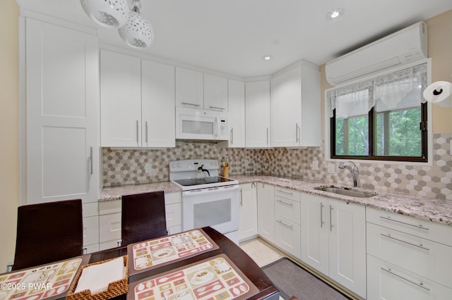 116 Rainbow Dr, Lackawaxen, PA 18435 - kitchen featuring white appliances, a sink, a wall mounted AC, decorative backsplash, and white cabinets