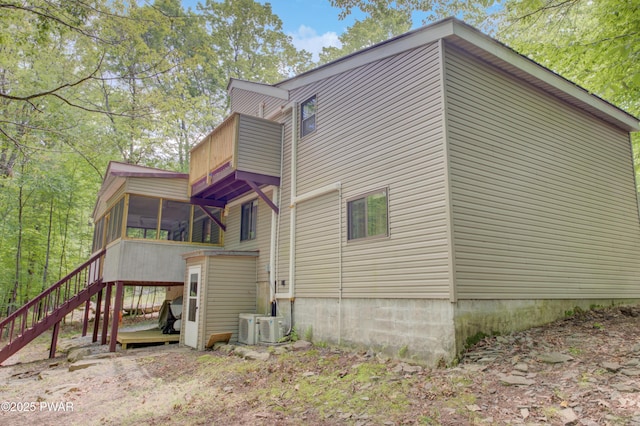 116 Rainbow Dr, Lackawaxen, PA 18435 - view of property exterior featuring a sunroom and stairs