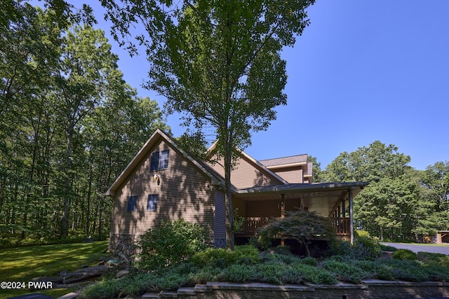 view of property exterior featuring a lawn