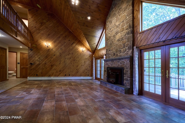 unfurnished living room featuring a fireplace, high vaulted ceiling, a baseboard radiator, and french doors