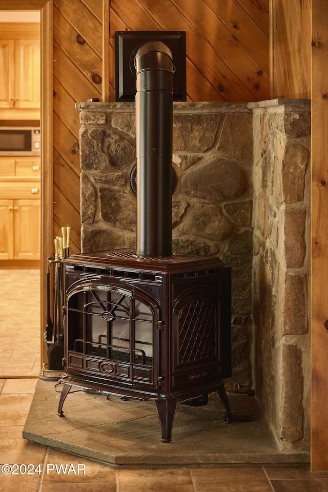 details with a wood stove and wood walls