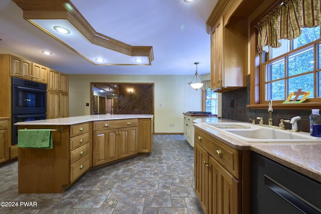 kitchen featuring a center island, black appliances, sink, tasteful backsplash, and decorative light fixtures