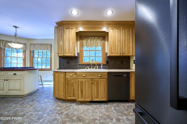 kitchen featuring stainless steel refrigerator, sink, hanging light fixtures, black dishwasher, and backsplash