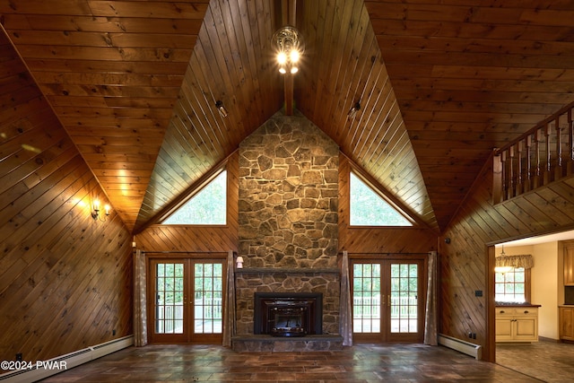 unfurnished living room with french doors, a baseboard radiator, and high vaulted ceiling