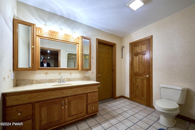 bathroom with tile patterned floors, vanity, and toilet