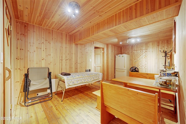 380 Falling Waters Blvd, Lackawaxen, PA 18435 - bedroom featuring freestanding refrigerator, wood-type flooring, wood ceiling, and wood walls