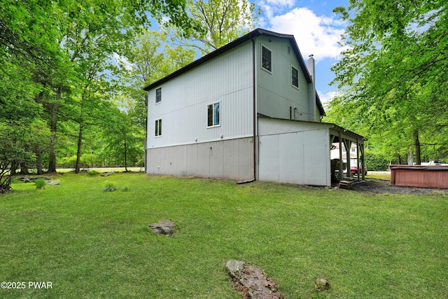 380 Falling Waters Blvd, Lackawaxen, PA 18435 - view of property exterior with a hot tub, a yard, and a chimney