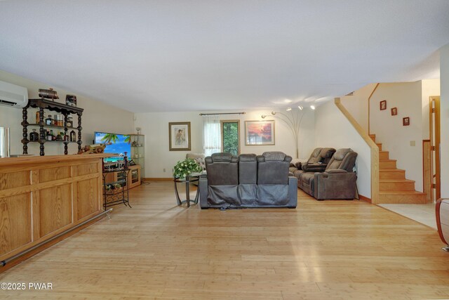 380 Falling Waters Blvd, Lackawaxen, PA 18435 - living area featuring light wood-type flooring, stairs, and a wall unit AC