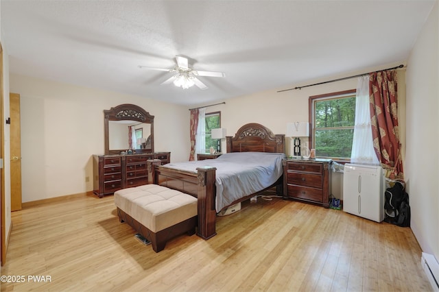 380 Falling Waters Blvd, Lackawaxen, PA 18435 - bedroom featuring light wood-style flooring, a baseboard radiator, and ceiling fan