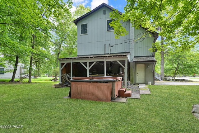 380 Falling Waters Blvd, Lackawaxen, PA 18435 - back of property with a hot tub and a lawn