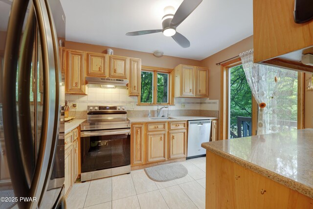 380 Falling Waters Blvd, Lackawaxen, PA 18435 - kitchen with appliances with stainless steel finishes, a sink, under cabinet range hood, light brown cabinets, and backsplash