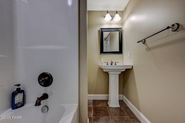 bathroom with tile patterned flooring, tub / shower combination, and baseboards