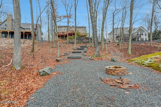 view of yard featuring a deck and an outdoor fire pit