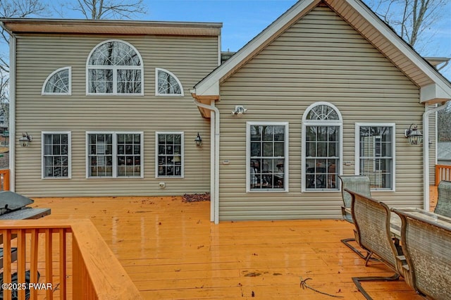 rear view of property featuring a deck