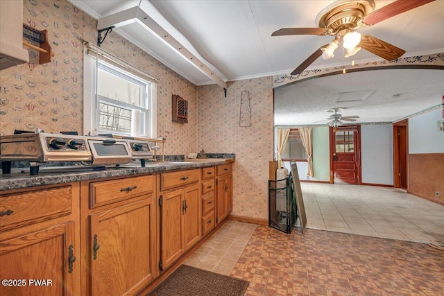 kitchen featuring crown molding, ceiling fan, and light tile patterned flooring