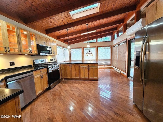 kitchen featuring wood ceiling, stainless steel appliances, lofted ceiling with skylight, hardwood / wood-style flooring, and hanging light fixtures