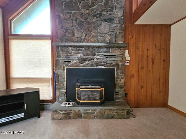 details with carpet flooring, a wood stove, and wooden walls