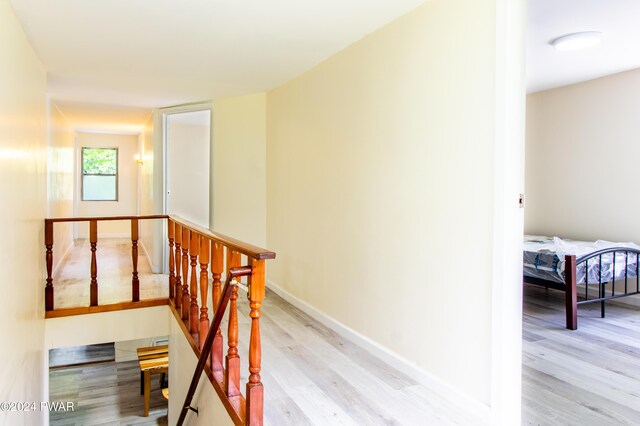 hallway with light hardwood / wood-style floors