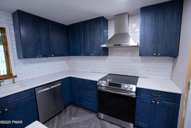 28 Woodcrest Ln, Lake Ariel, PA 18436 - kitchen featuring wall chimney exhaust hood, appliances with stainless steel finishes, backsplash, and blue cabinets