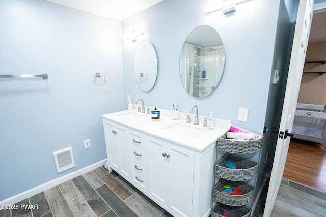 28 Woodcrest Ln, Lake Ariel, PA 18436 - ensuite bathroom featuring double vanity and wood finished floors