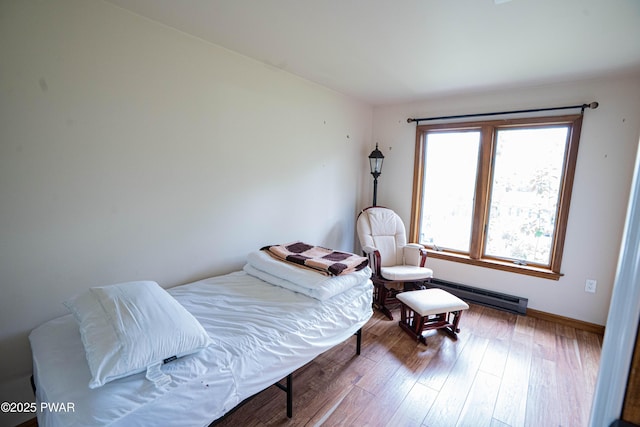 28 Woodcrest Ln, Lake Ariel, PA 18436 - bedroom with wood finished floors and a baseboard heating unit