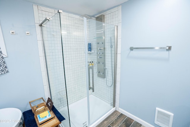 28 Woodcrest Ln, Lake Ariel, PA 18436 - full bathroom with wood finished floors, a stall shower, and a freestanding bath