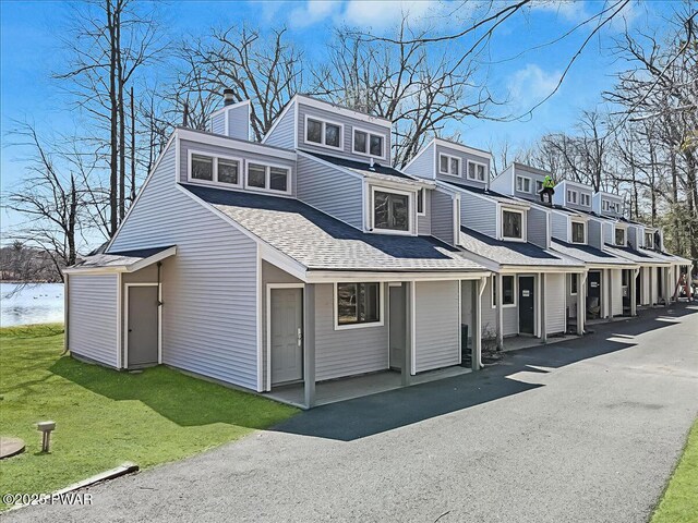 134 Laurel Hill Dr Unit 102, Greentown, PA 18426 - view of front of home with roof with shingles, a chimney, and a front yard