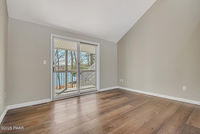 134 Laurel Hill Dr Unit 102, Greentown, PA 18426 - spare room with visible vents, baseboards, vaulted ceiling, and hardwood / wood-style flooring